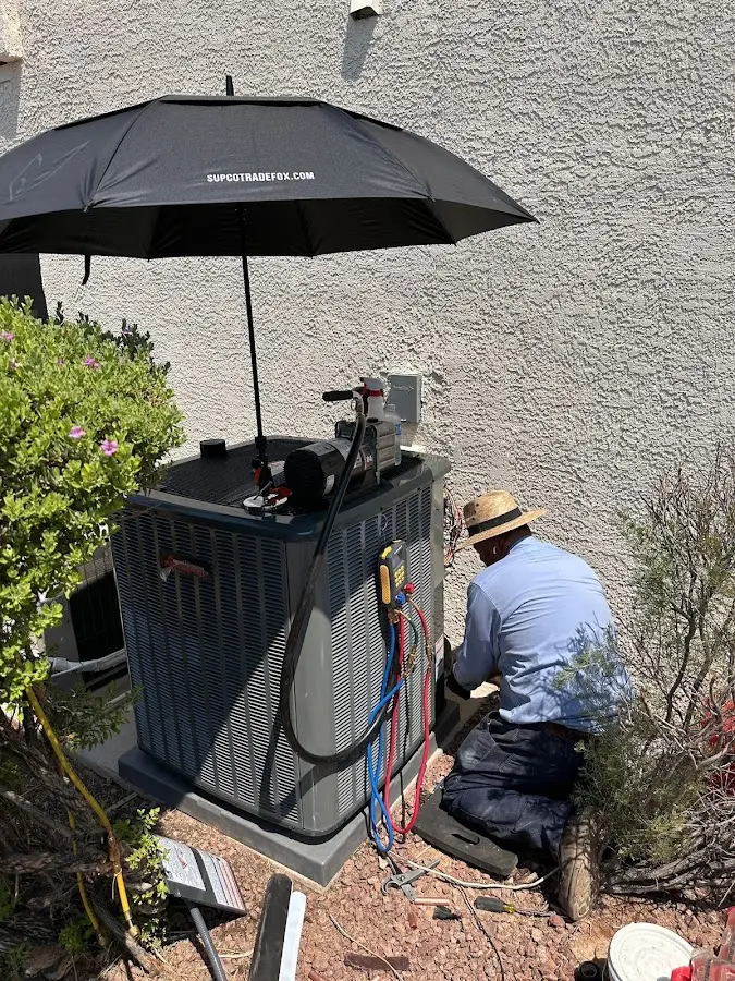 HVAC technician performing outdoor AC maintenance in Mattoon